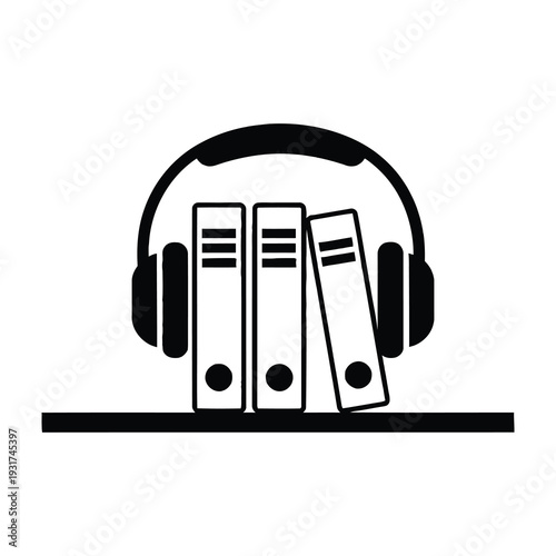 Headphones resting on three books for audio learning or study session concept