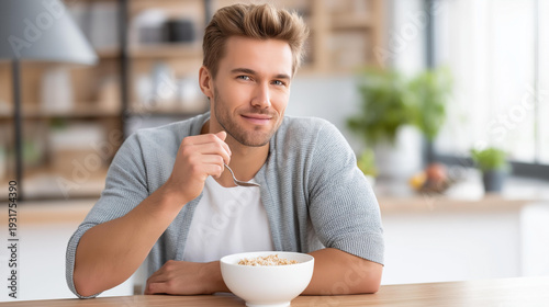 Wallpaper Mural Young adult man eating cereal at a modern bright kitchen table in the morning, healthy weekend breakfast routine, calm morning home lifestyle, nutritious start to weekend, New Year wellness Torontodigital.ca