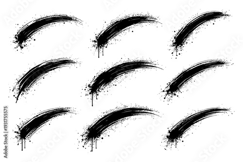 Set of nine black grunge brush strokes on white background.