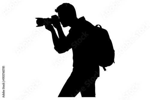 Silhouette of young male photographer carrying backpack and holding camera.