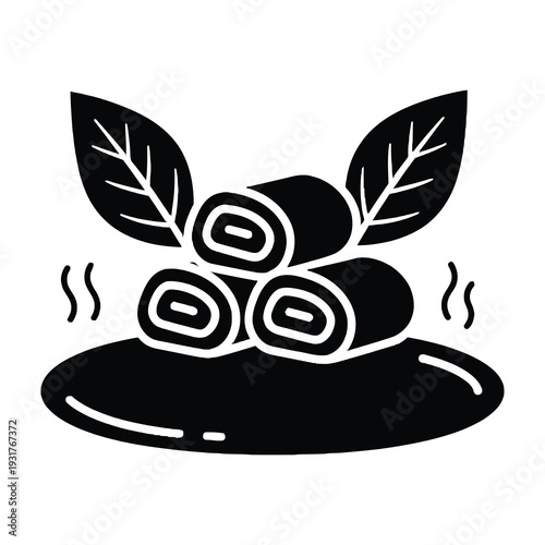 Freshly rolled sushi served on a dark plate with steam and green leaves