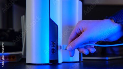 Принти на полотні Close-up of a hand plugging an Ethernet cable into a modern mesh Wi-Fi router