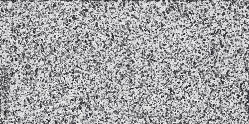 Abstract monochrome textured background with a dense speckled pattern of dark and light gray granular elements creating a visually complex and artistic surface for design
