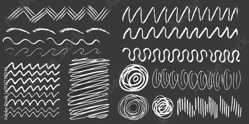 Variety of hand drawn white chalk lines and shapes on a black background