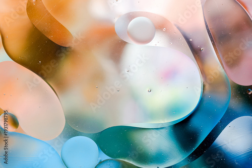 Close-up of the movement of oil droplets on the water surface. Colorful abstract macro background of oil drops on the water surface.