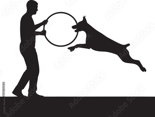 Dog jumping through hoop training session silhouette with man holding equipment for pet agility performance and active lifestyle