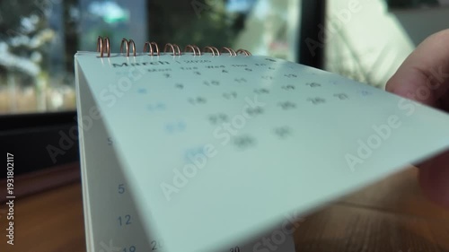 Slow motion footage of flip calendar pages for change months from march to april of the year 2026. concept of planning and starting a new month. 4k horizontal