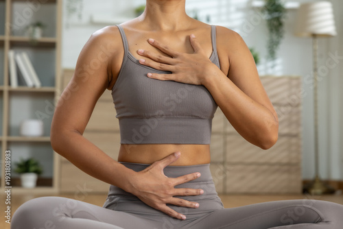 Bild auf Leinwand Closeup shot showing peaceful young fit woman practicing yoga breathing exercise