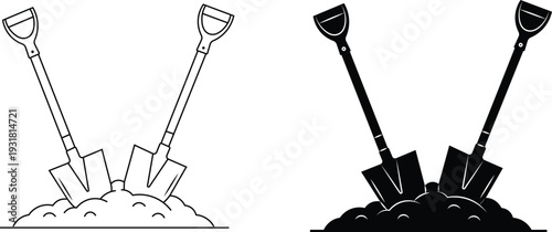 Shovels in a pile of dirt in black and white