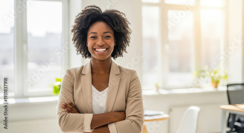 Professional black woman with crossed arms smiling confidently in a bright office