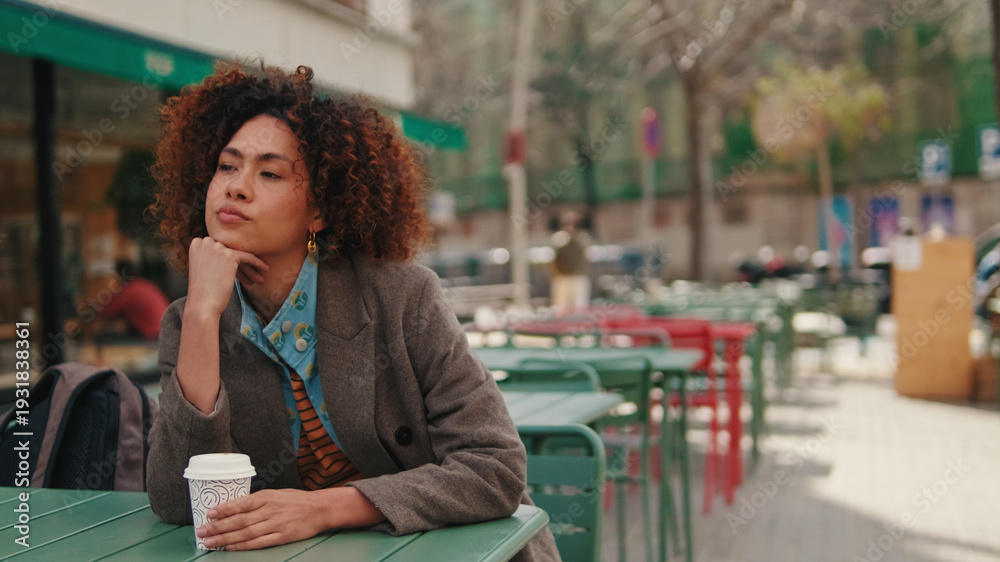 Fototapeta premium Thoughtful Woman At Outdoor Café With Coffee