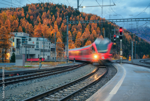 Blurred red passenger train...