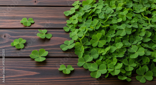 A bunch of green clover on a wooden surface