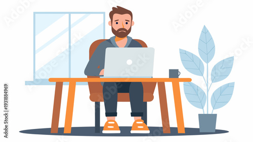 Bearded man working on laptop at wooden desk in office