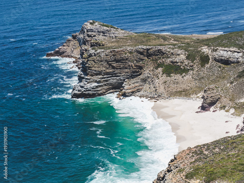 Stunning coastal landscape at Cape of Good Hope, South Africa. Turquoise ocean, rugged cliffs and secluded sandy beach. Nature and travel inspiration. Scenic coastal view