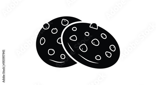 Two chocolate chip cookies presented in a striking black silhouette