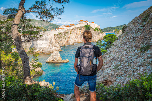 Konstfotografi Backpacker Seen from Behind Standing on a Rock at the Viewpoint of Old Fortress