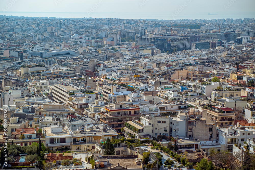Fototapeta premium Athens, Greece: Aerial view of dense city buildings and ocean horizon