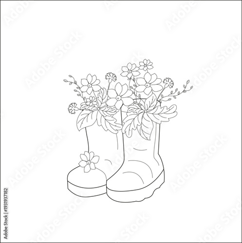 Pair of rubber boots used as a vase for garden flowers. Cozy spring or autumn gardening concept.