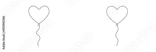 Heart-shaped balloons floating gently in a clear sky during a celebration event