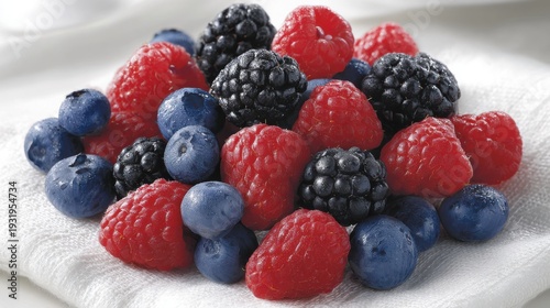 A vibrant assortment of fresh raspberries, blueberries, and blackberries bursting with color and flavor.