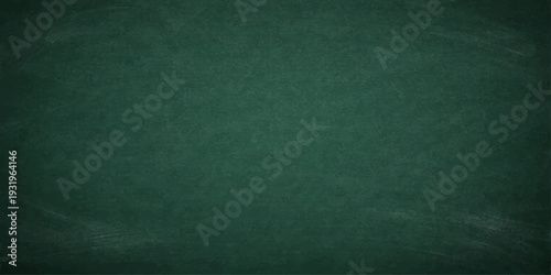 Empty vintage green chalkboard backdrop with a rough grunge texture and dark weathered material for an artistic blank wallpaper design
