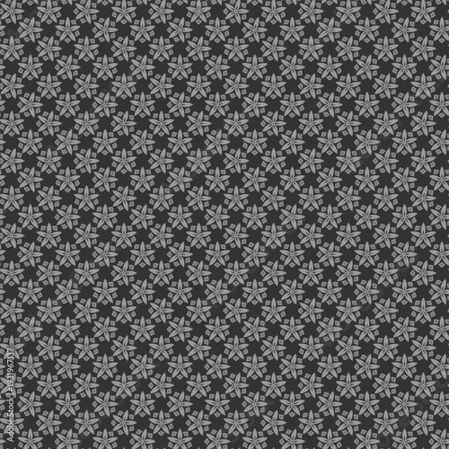 Geometric pattern featuring stylized flower and diamond shapes in grey tones