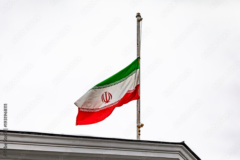 Fototapeta premium The Iranian flag at half-mast on the roof of the embassy building during the mourning period