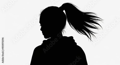 Silhouette of young woman with flowing ponytail hair