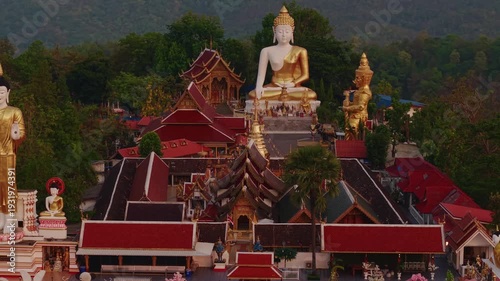 Aerial view of Wat Phra That Doi Kham, Buddha pagoda and golden chedi in Chiang Mai, Thailand.