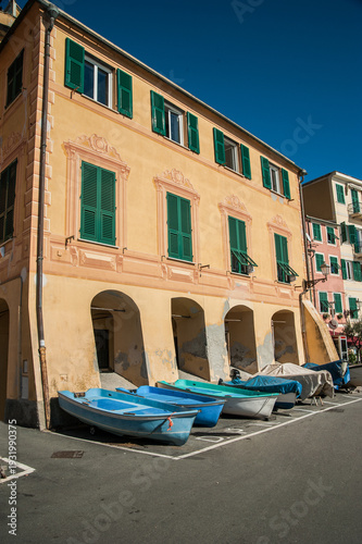 Old building with arches, shuttered windows and stored boats