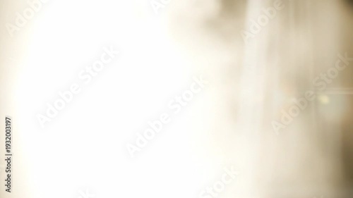 Soft luminous white flare wash transition inspired by natural sunlight flooding the lens, gradual build from subtle glow to complete whiteout with creamy highlight roll-off and delicate lens