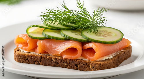 Smoked Salmon Smorrebrod on Dark Rye Bread with Fresh Cucumber Slices and Dill Garnish