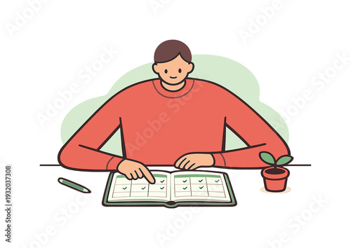 Young man checking off tasks in a planner with a small plant on the side
