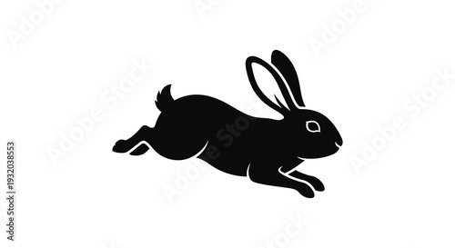 A sleek black silhouette of a rabbit in mid leap