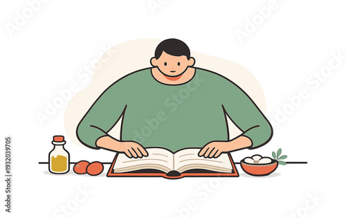 Person reading a cookbook with ingredients for cooking laid out on the table