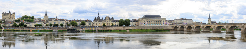 Fototapeta premium Saumur panorama, France, located at the Loire river under a beautiful cloudscape during daytime.