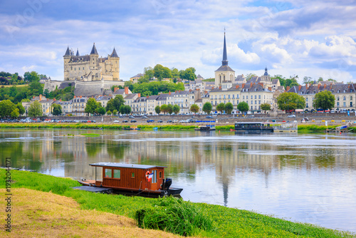 Saumur, France, located at the Loire river under a beautiful cloudscape during daytime.