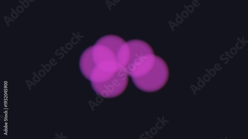 Pink Cells Dividing Against Dark Background.