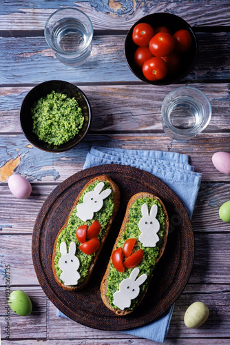 Pesto sauce mozzarella cheese in the form of rabbit rye sandwich in a plate for Easter holidays