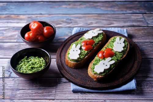 Pesto sauce mozzarella cheese in the form of rabbit rye sandwich in a plate for Easter holidays