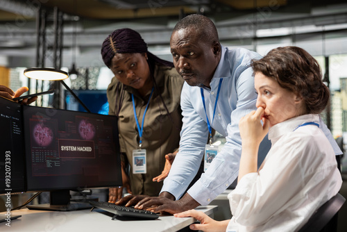 Tableau sur toile Programmer in startup office requesting help from coworkers to fix hacking attempt warning