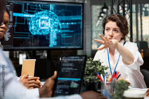 Photos Data scientists in artificial intelligence startup office brainstorming, building scalable solutions for businesses