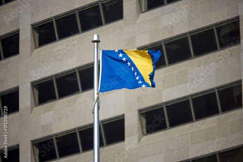 Bild auf Leinwand The Bosnian flag on a flag pole at Toronto City Hall's Nathan Phillips Square