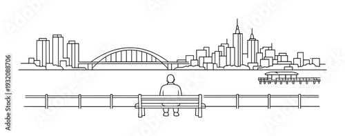 Person on bench facing arched bridge and city skyline across river
