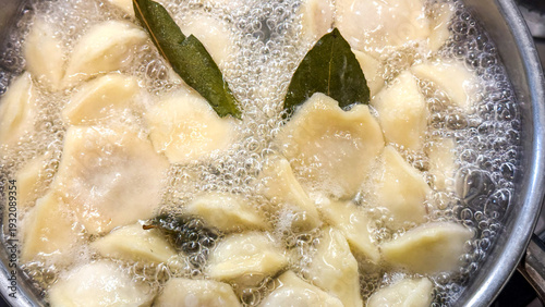 Obraz na plátně Boiling pierogi float amidst bubbling joy, celebrating Polish Wigilia traditions