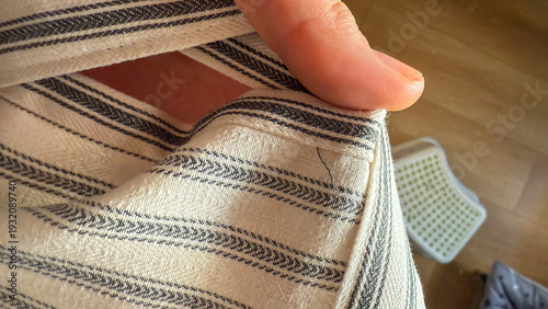 Photos Fingers delicately pinch a homespun linen cloth, echoing rustic aesthetics and S