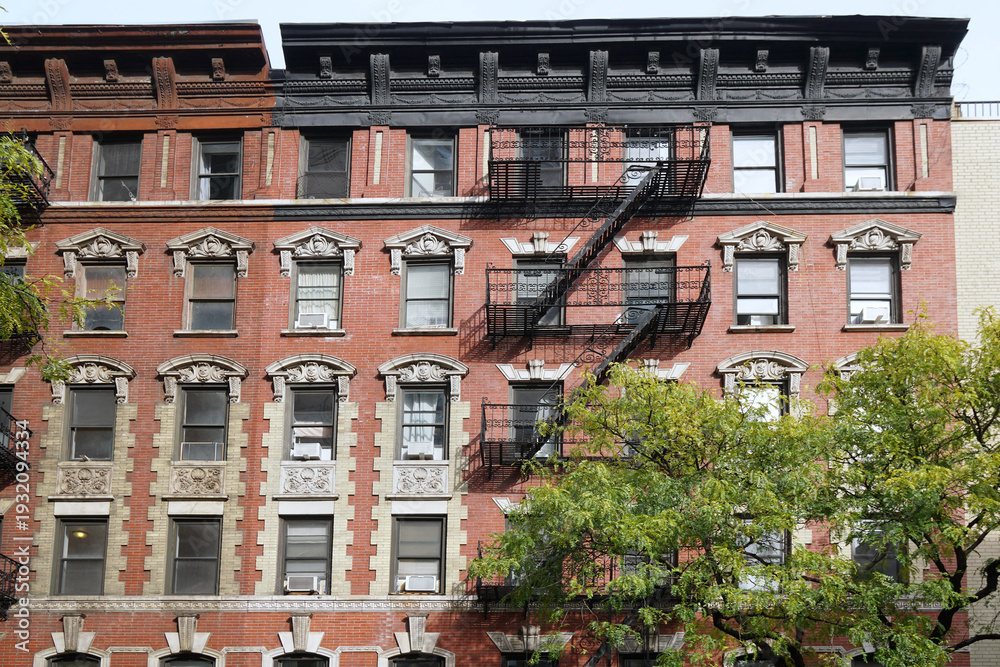 Fototapeta premium New York, old apartment building with stone decorations around window frames