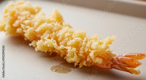 Golden Crisp Tempura Shrimp: a single, perfectly fried tempura shrimp sits gracefully, its golden, airy batter revealing the succulence within.