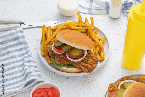 Bild auf Leinwand Massive fried pork tenderloin sandwich with french fries